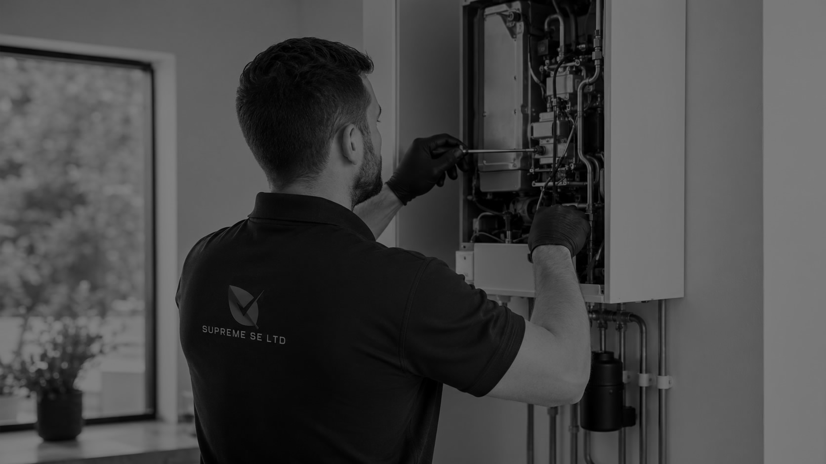 Heating engineer servicing a boiler